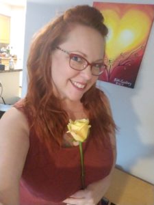 Nikki Ivana, the Las Vegas Masseuse, holding a yellow rose